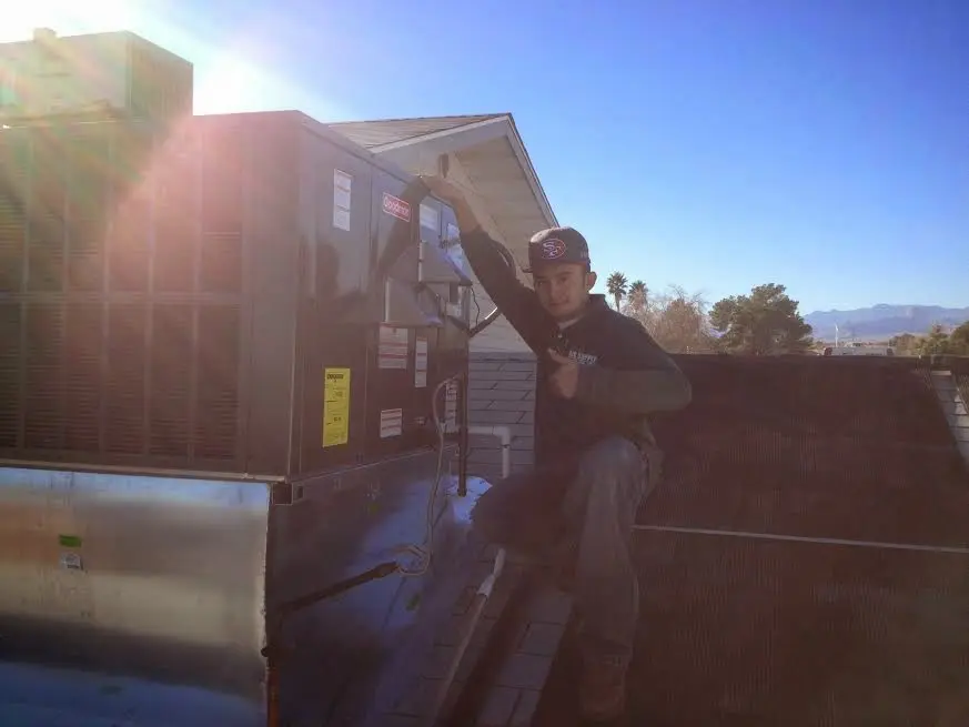 HVAC technician performing HVAC Inspection on a rooftop unit in Mead Valley
